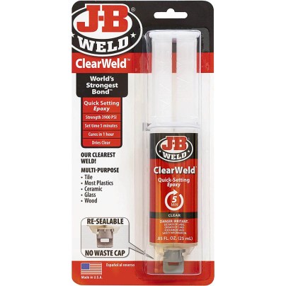 A red, white, and black tube of the J-B Weld 50112 ClearWeld Quick-Setting Epoxy in its packaging on a white background.