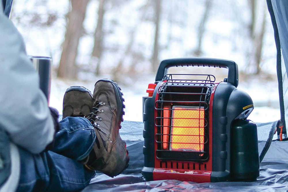 A person using the Mr. Heater MH9BX tent heater