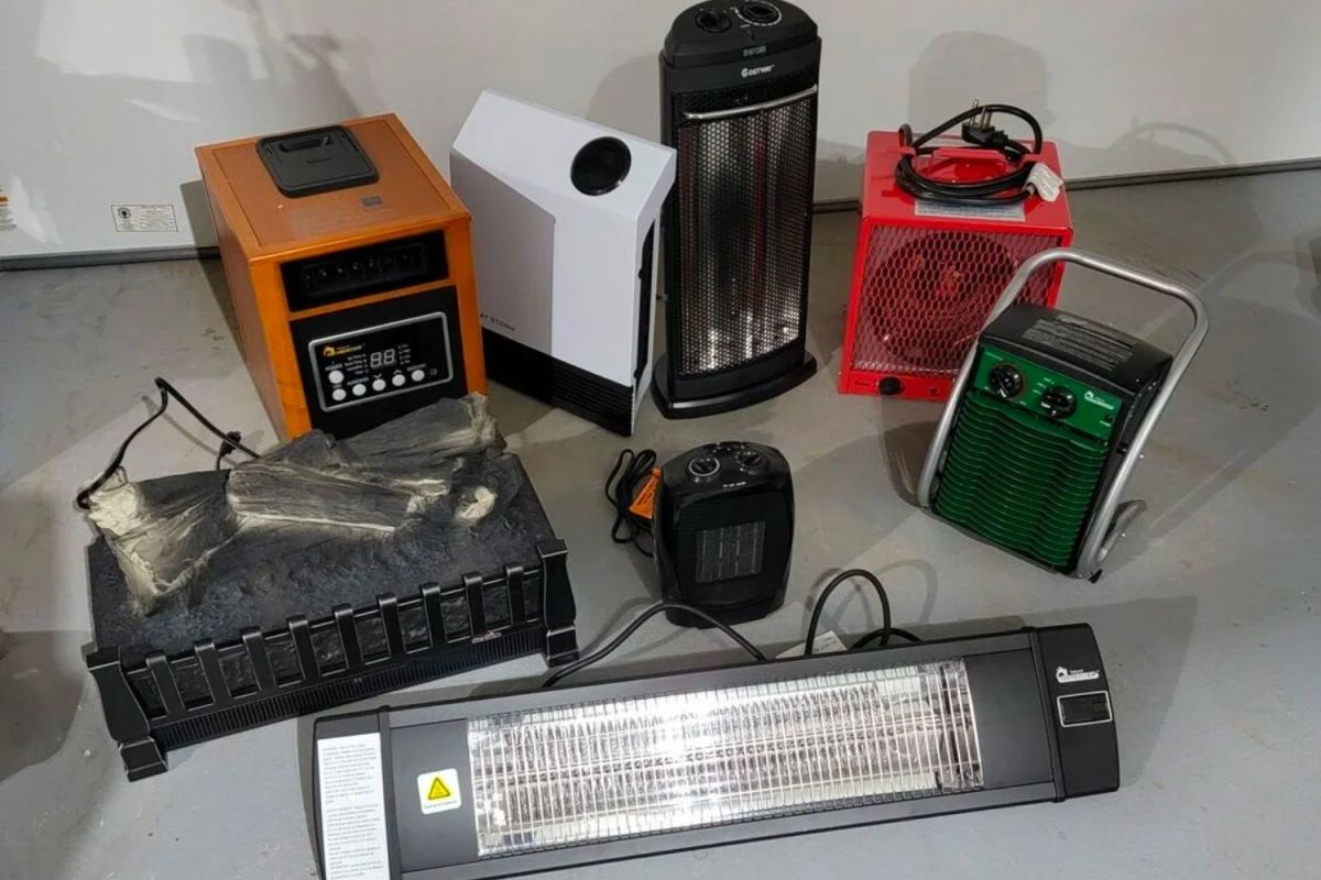 A group of the best infrared heaters on a garage floor before hands-on testing.