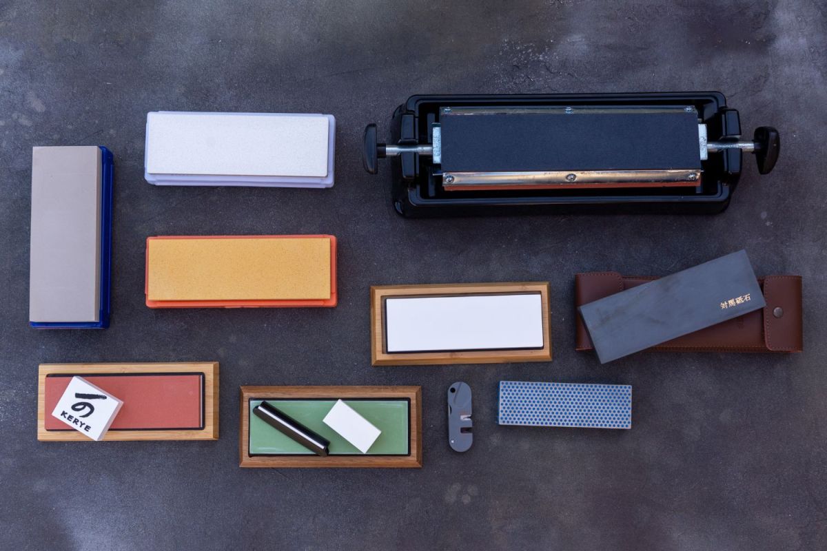 A group of the best sharpening stone options laid out together on a dark surface.