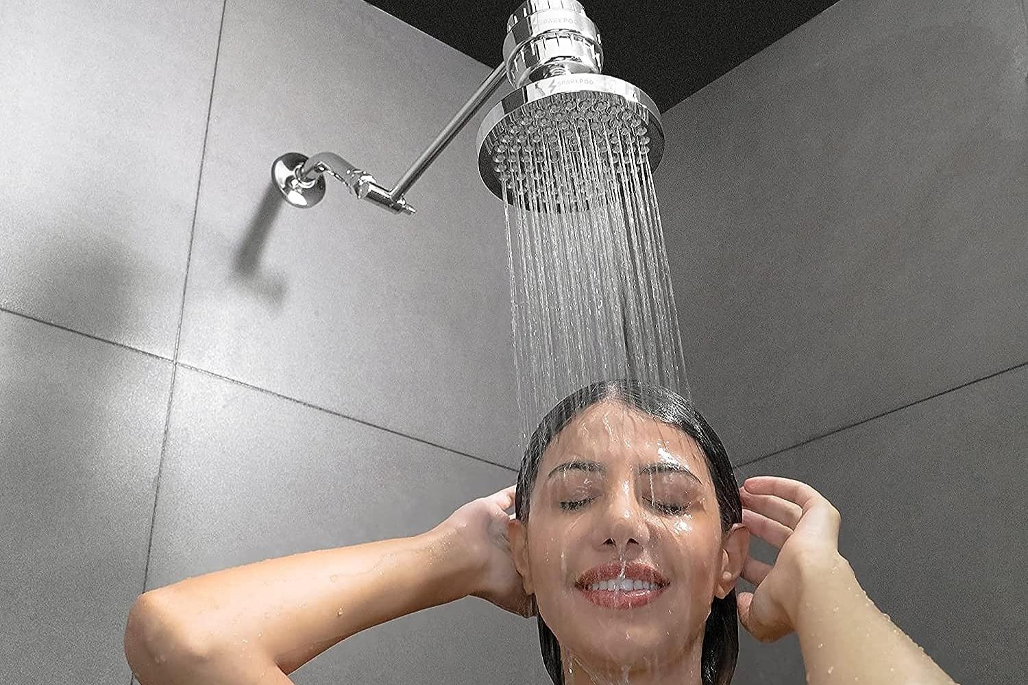 A person using the leading rain shower head to deliver a luxurious and invigorating shower experience