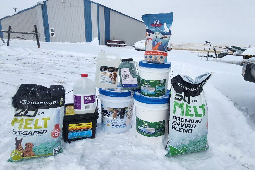 A group of the 10 best ice melts on a snowy and icy outdoor cement surface before testing.