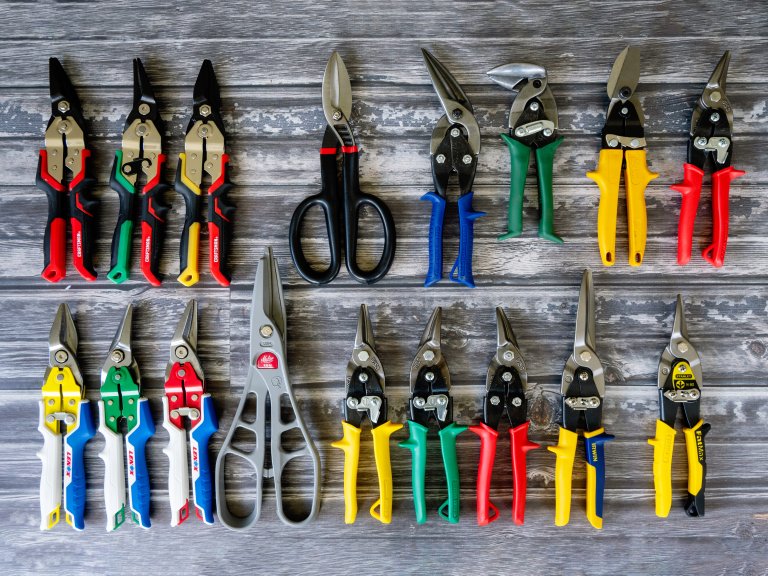 A large group of the best tin snips on a table before testing.
