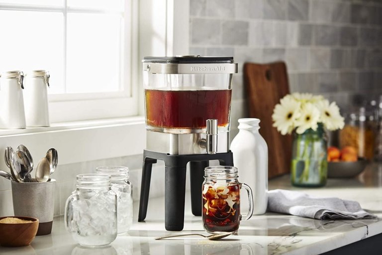 The Best Cold Brew Maker on a counter dispensing coffee into a glass with ice