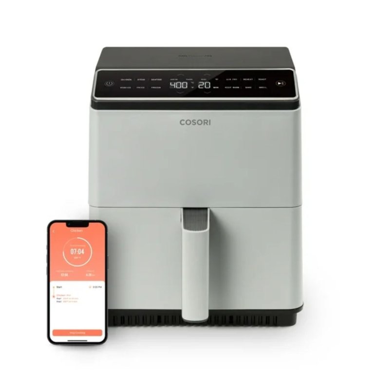 Cosori Smart Dual Blaze Air Fryer next to a smartphone