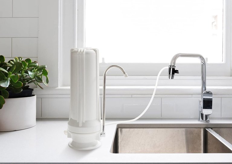 The Best Countertop Water Filter Option placed next to a kitchen sink and attached to its faucet
