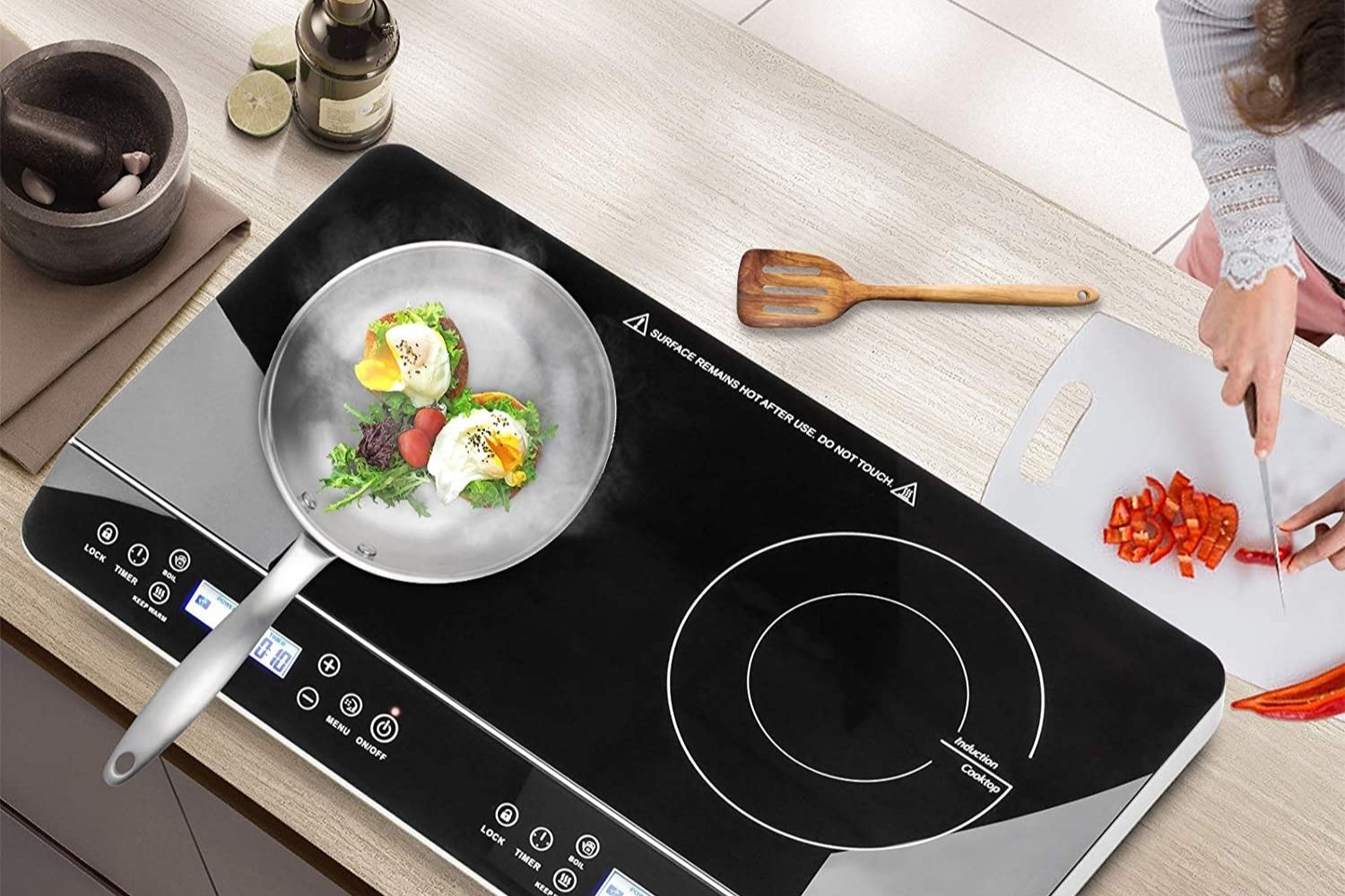 The best hot plate option on a kitchen counter with a pan on it cooking two eggs.