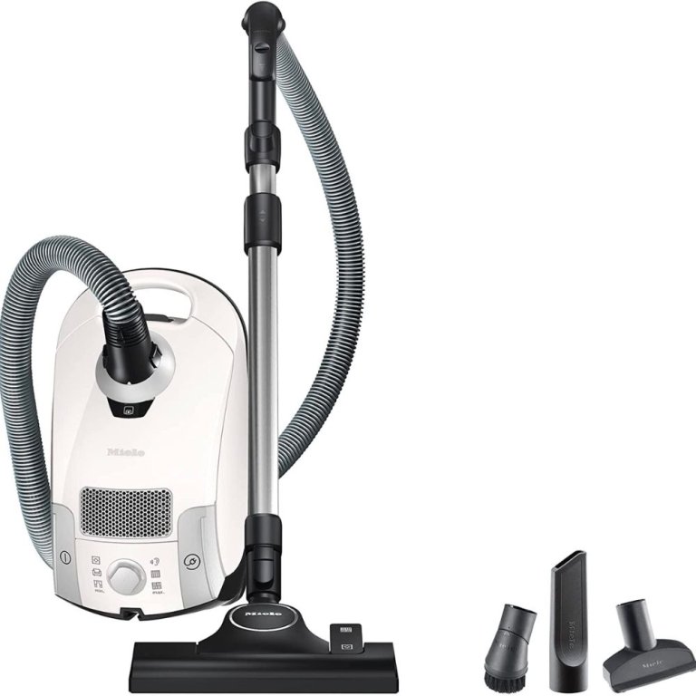  The Miele Compact C1 Pure Suction PowerLine and its accessories on a white background.
