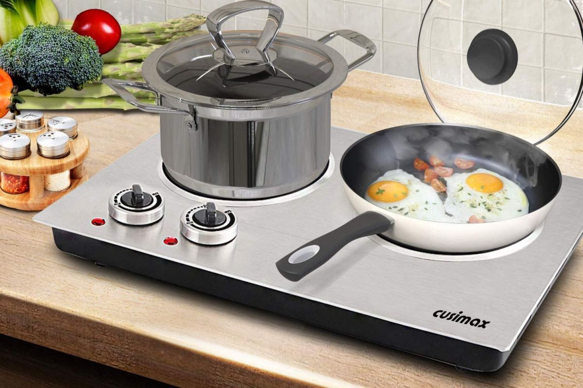 The best hot plate option with one burner cooking two eggs in a pan and the other holding a stock pot.