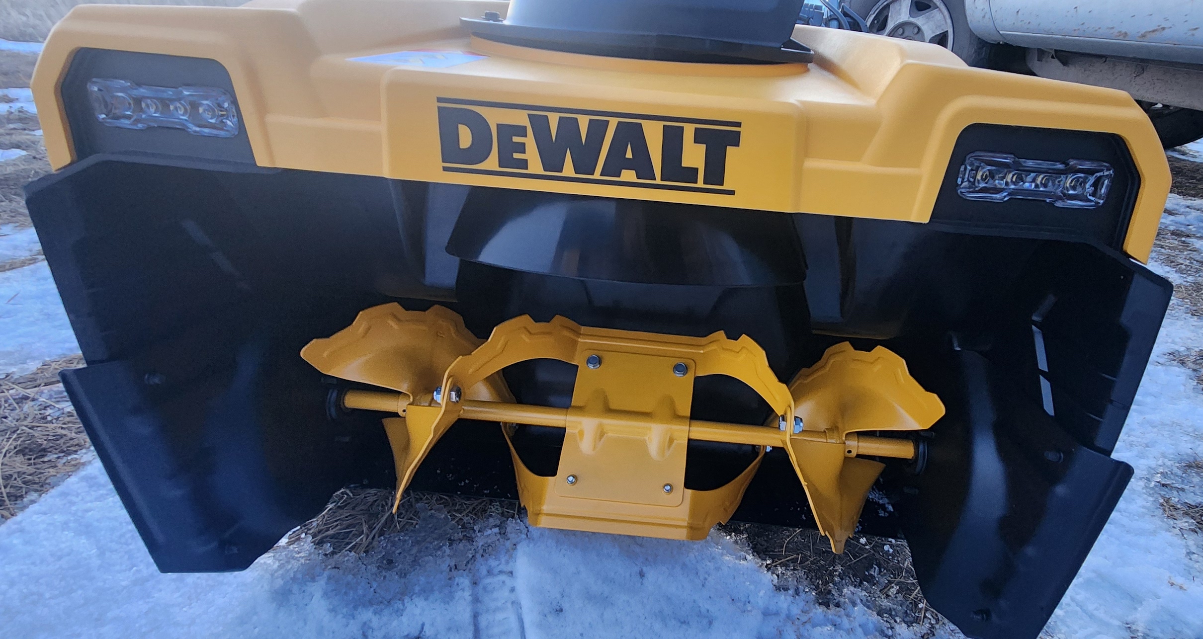 Dewalt snow blower positioned outside on a cleared driveway
