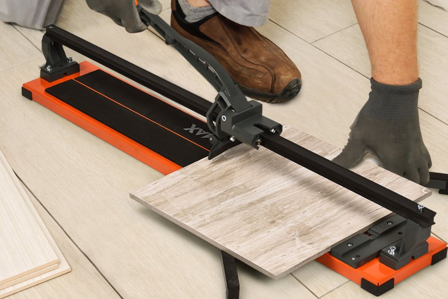A person using the best manual tile cutter option to manually cut a tile