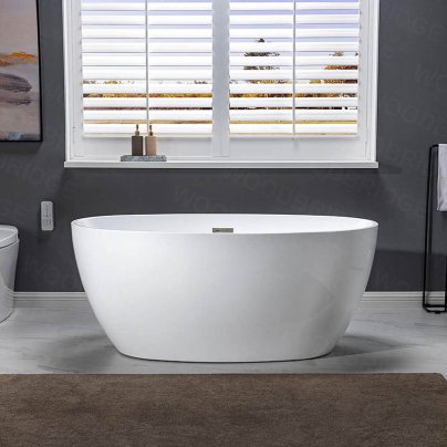 Woodbridge 55-Inch Acrylic Freestanding Bathtub in front of a window
