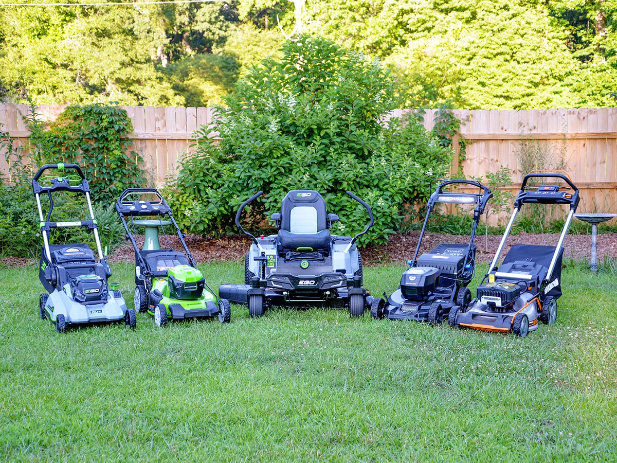 A group of the Best Battery-Powered Lawn Mower Options together on a green lawn.