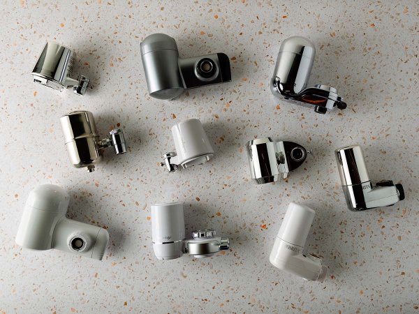 10 Water faucet filters laying on a white countertop