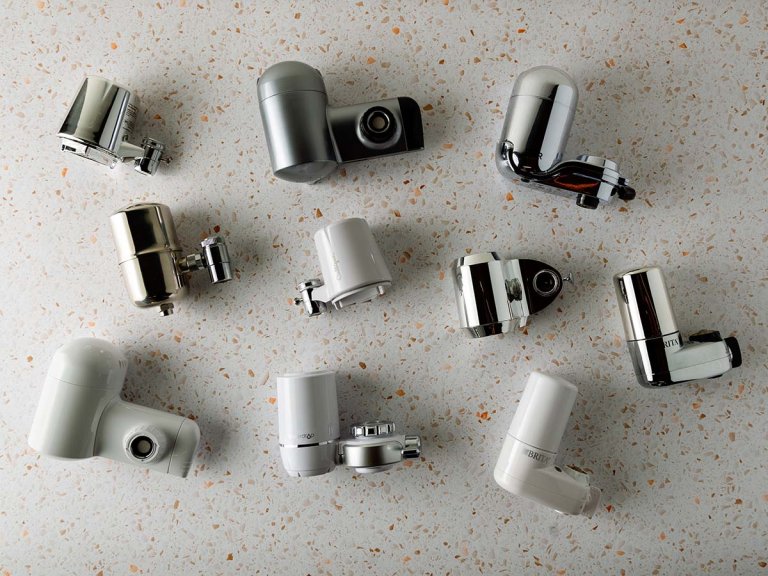 10 Water faucet filters laying on a white countertop