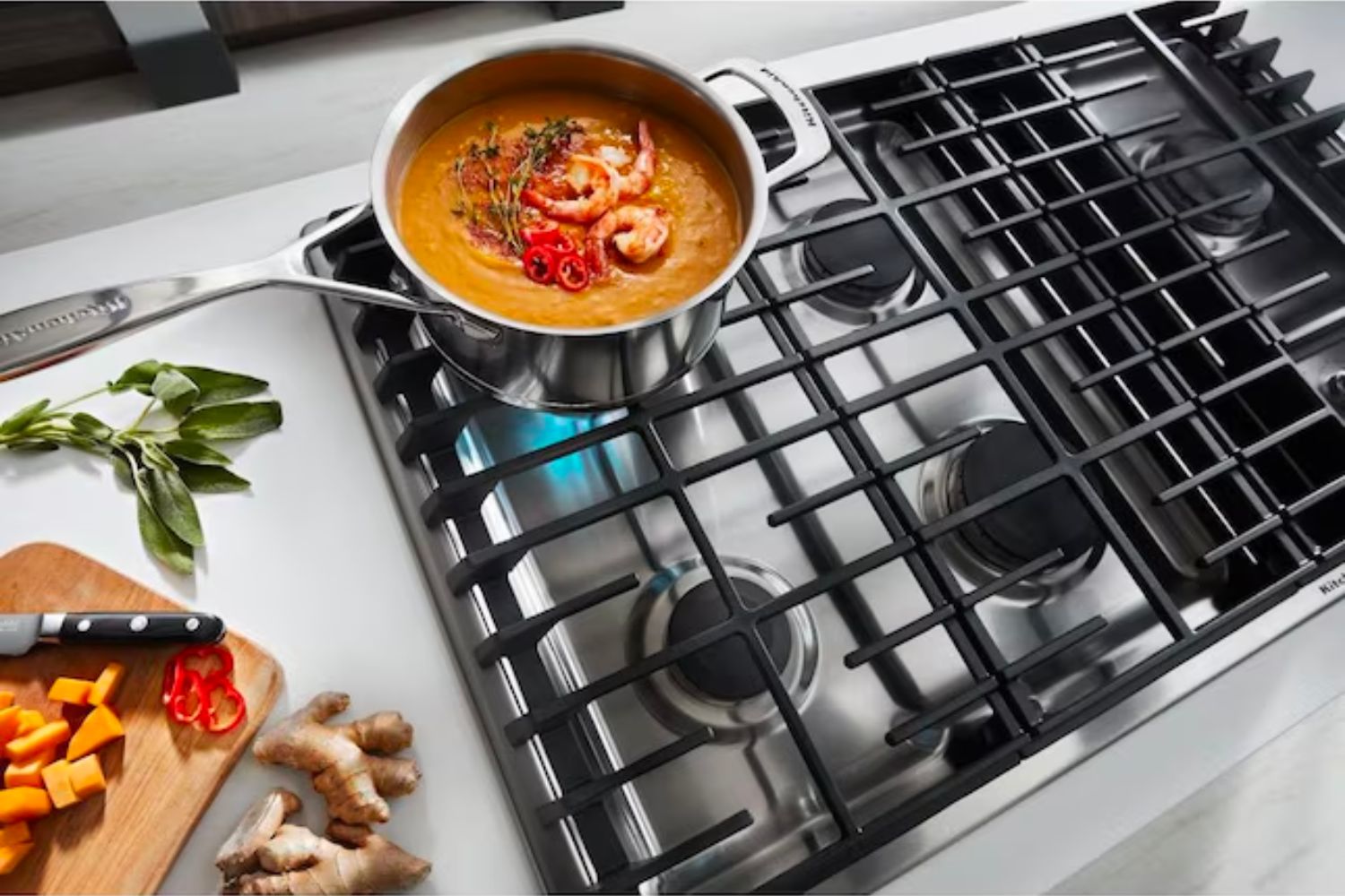 A pot of soup cooks on the best gas cooktop option