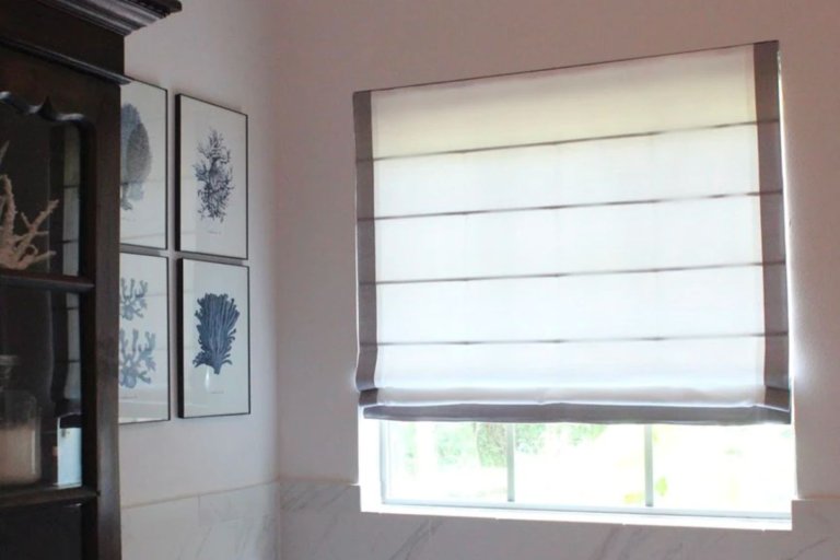 The best Roman shades option installed in a living room and partially closed to block a sunny day