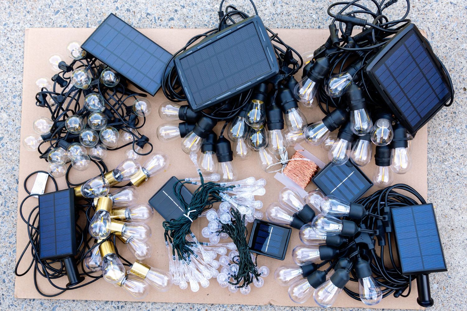 A group shot of the best solar string lights options bundled and laid out on a piece of cardboard