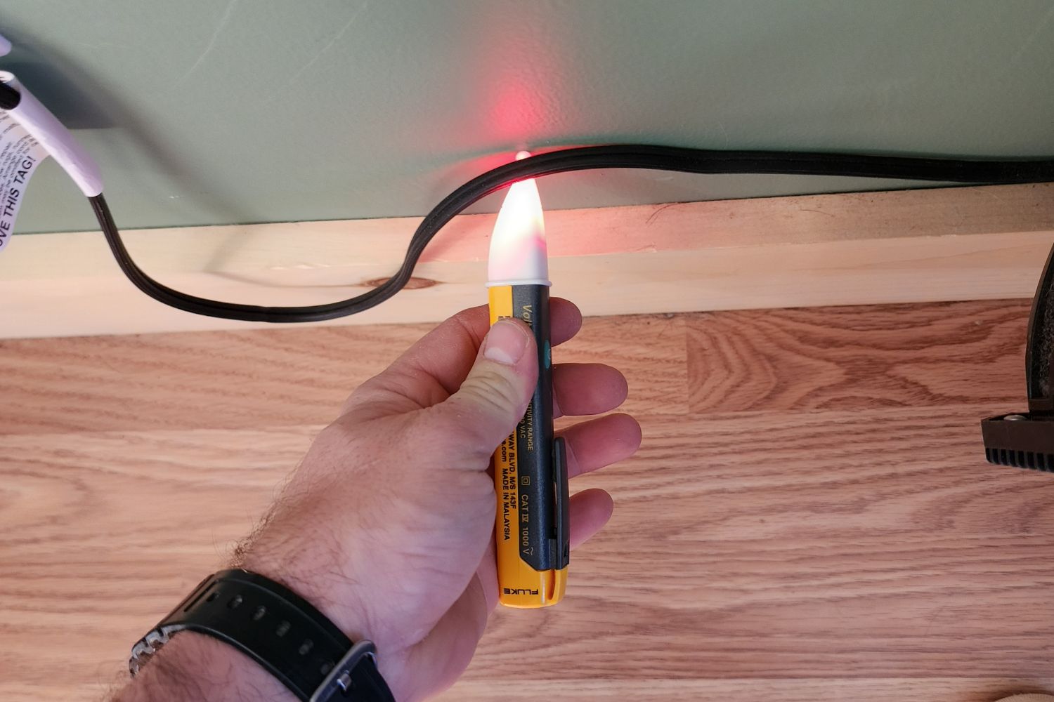 A person using the Sperry Instruments STK001 Non-Contact Voltage Tester to test an electrical cord.