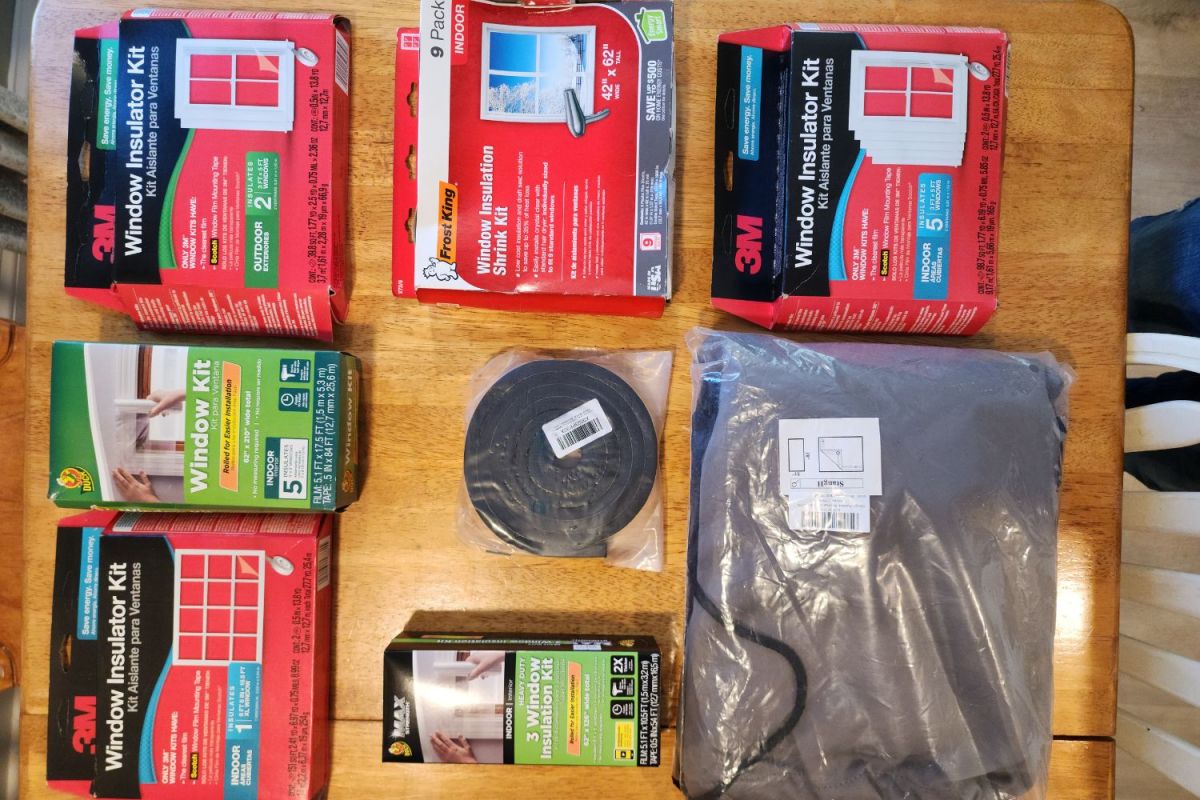A group of the best window insulation kits still in their packages together on a table before testing.