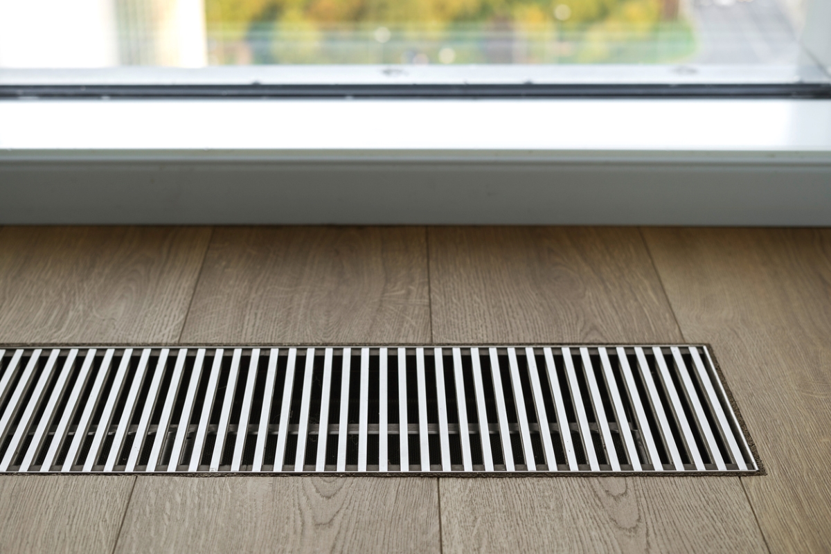 Modern air vent in hardwood floor.