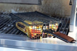 The Best Grill Basket filled with sliced vegetables to cook them on a grill.