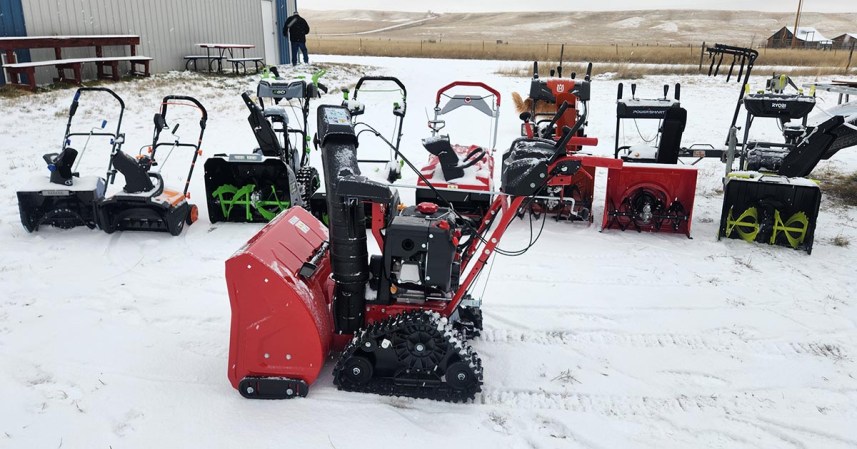 A group of the best snow blowers in a snowy ranch setting before testing.