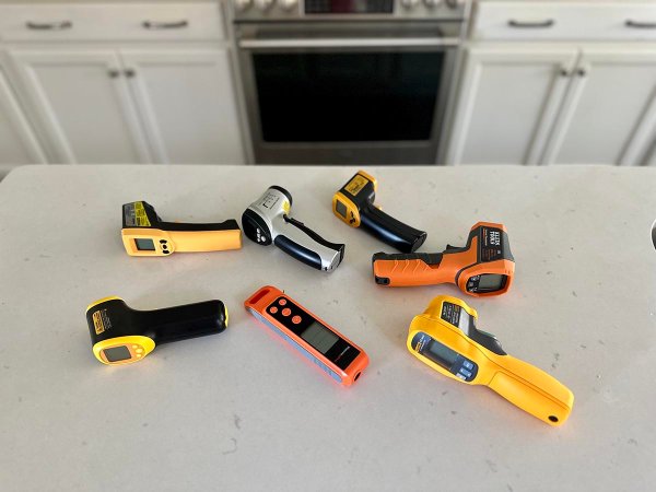 A group of the best infrared thermometers on a counter awaiting hands-on testing.