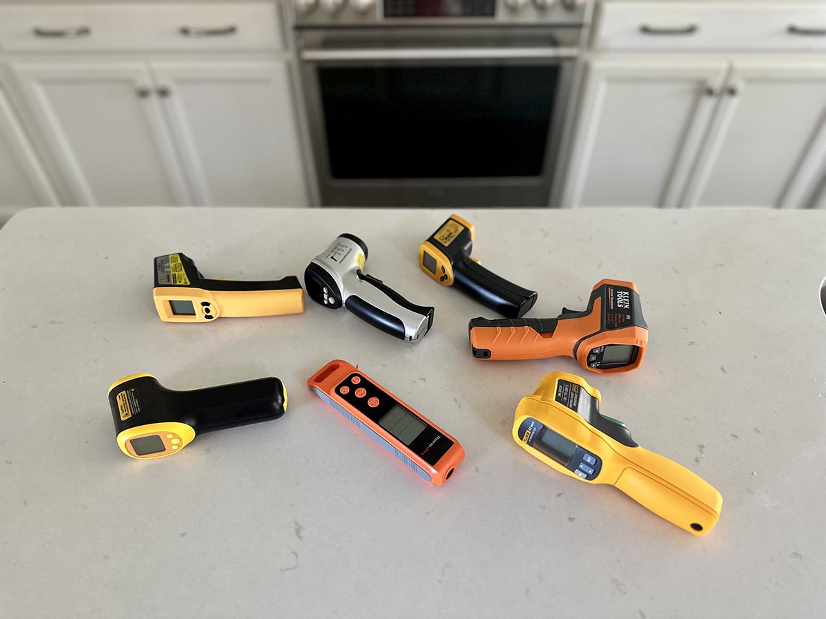 A group of the best infrared thermometers on a counter awaiting hands-on testing.
