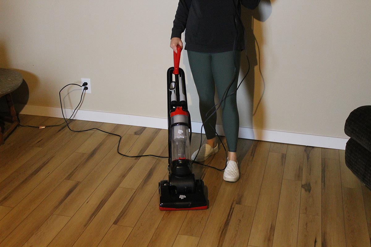 A person using the best lightweight vacuum to clean a laminate floor.