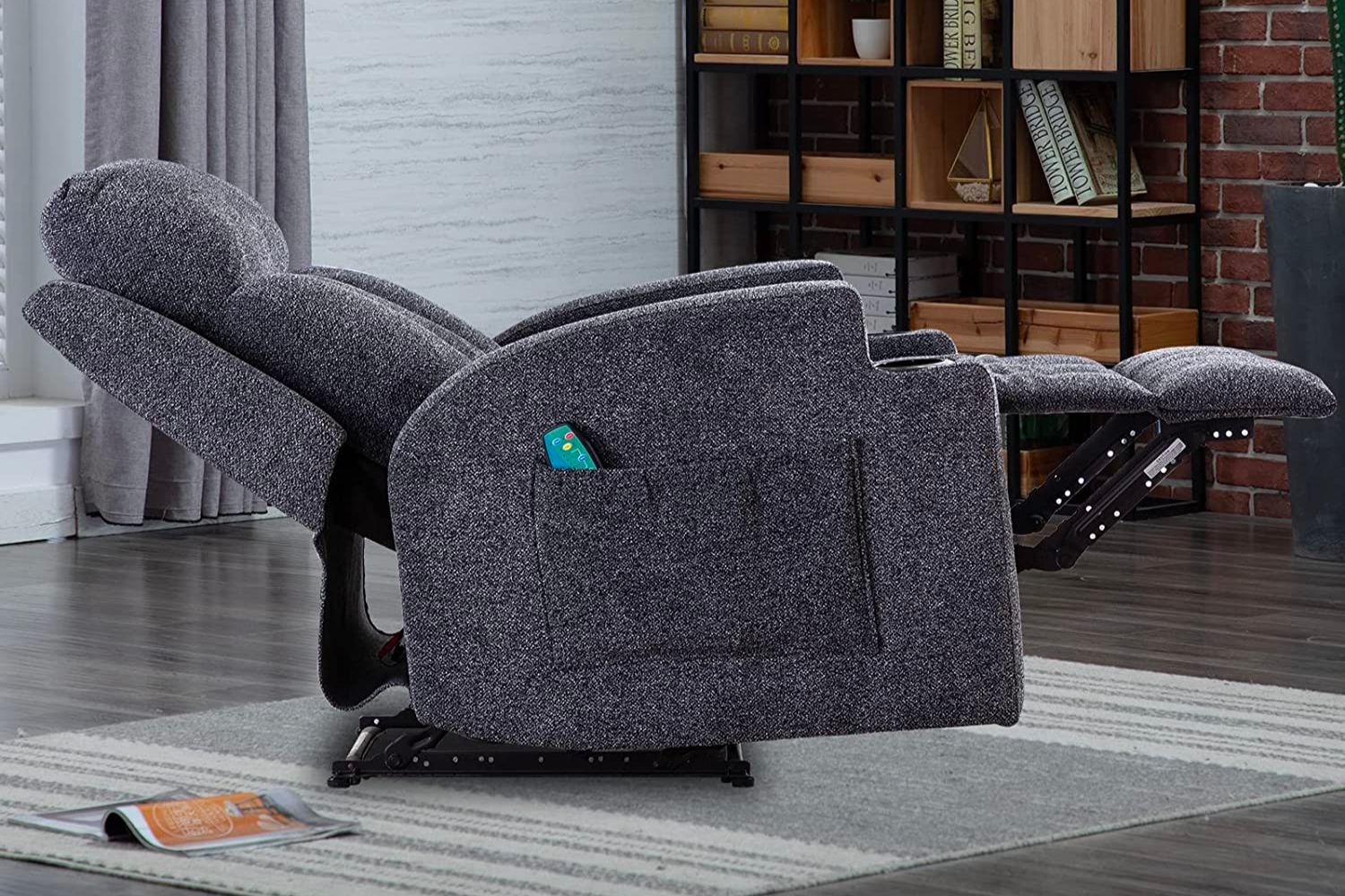The Best Recliners for Back Pain Option in a reclined position with its remote in a side pocket