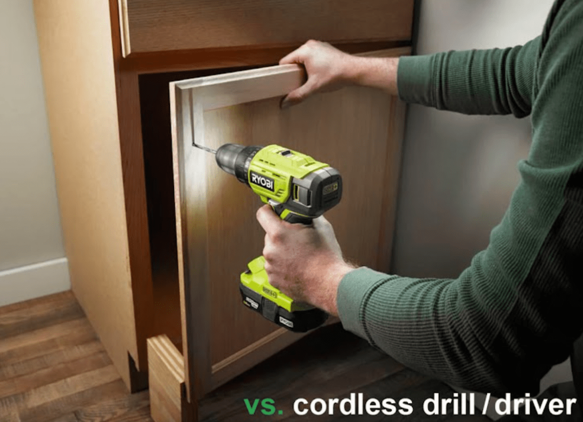 A man uses a lime green cordless drill on a cabinet.