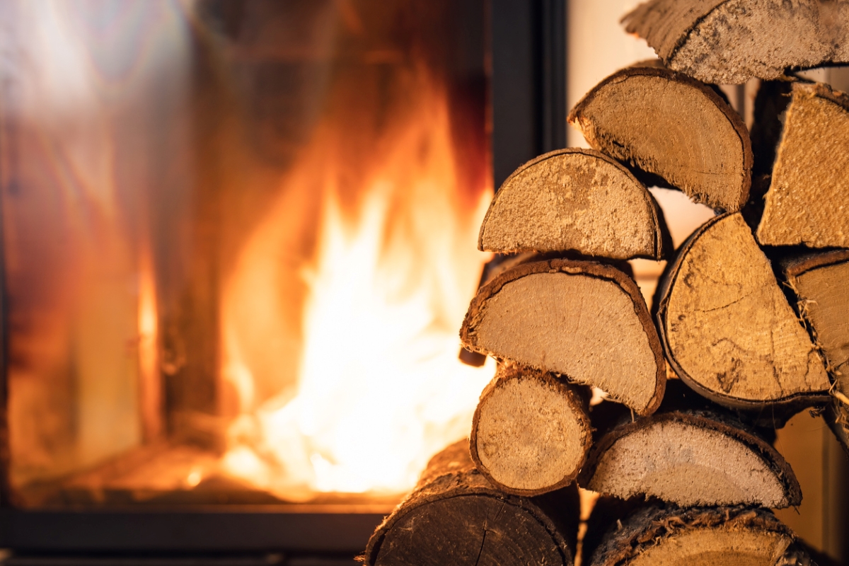 Firewood stacked in front of fire.