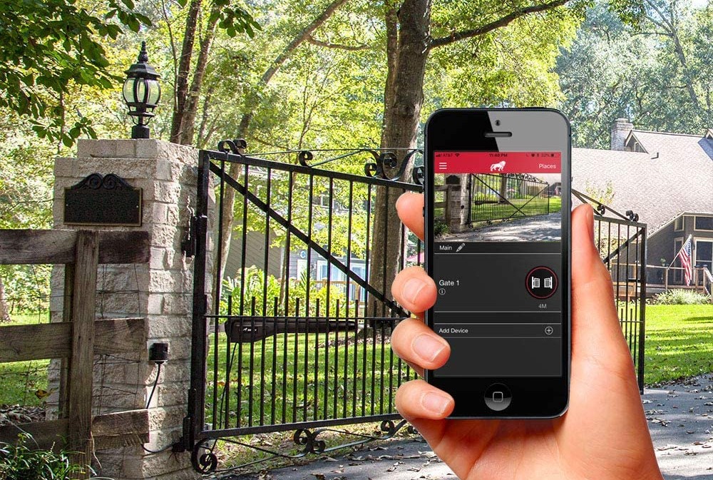 A person holding up a cell phone to show an app that controls the best automatic gate opener option