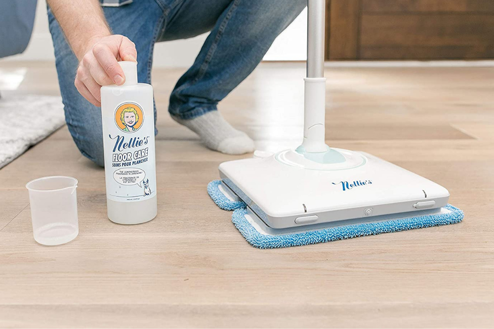 A person using the best mop for laminate floors to clean a kitchen floor