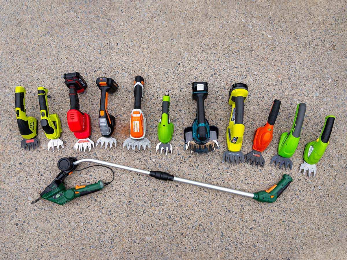 The Best Cordless Grass Shears Options all laid out in a group on cement