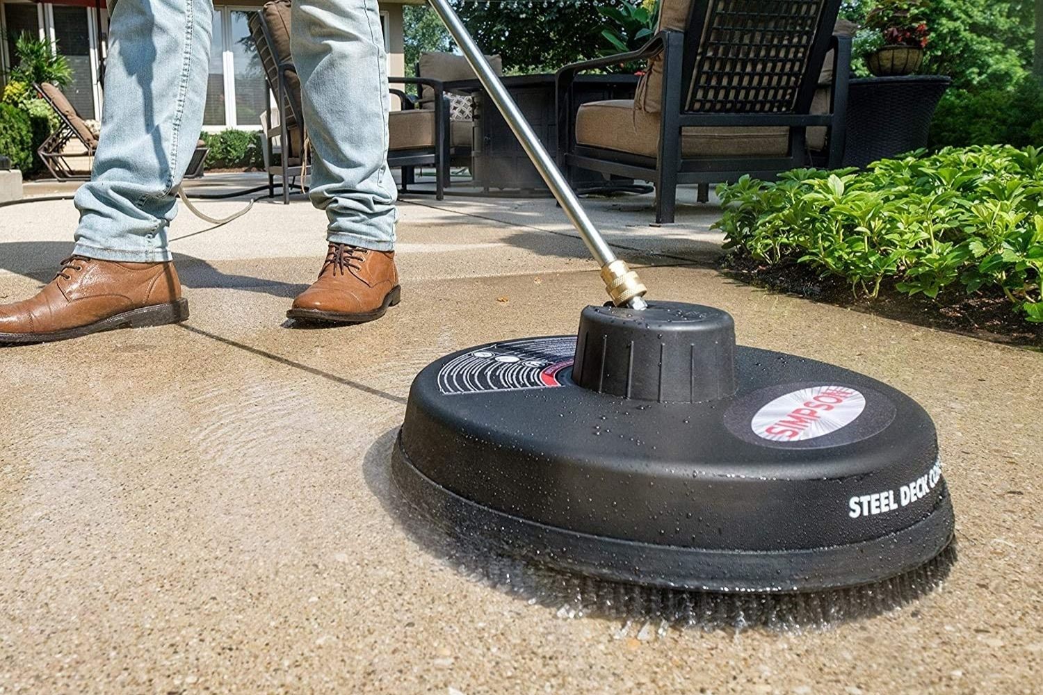 A person using the best gas pressure washer option to clean a cement patio