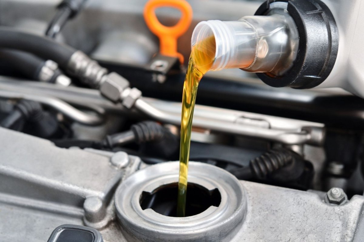 A close-up of the best oil for snow blower being added to a snow blower