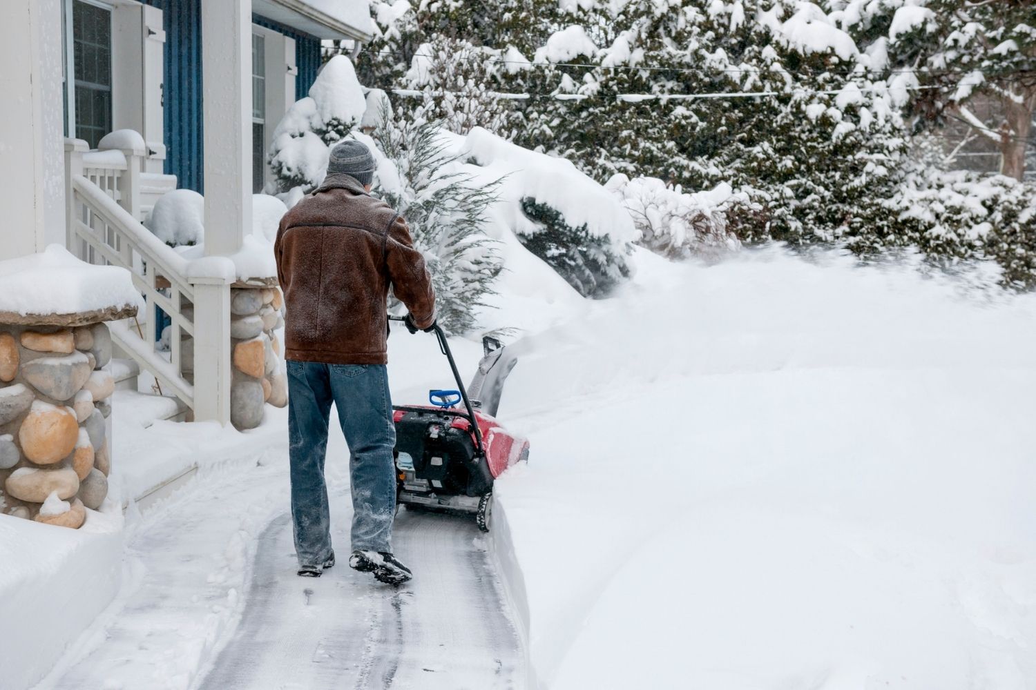 A person using a snow blower lubricated with the best oil for snow blower option