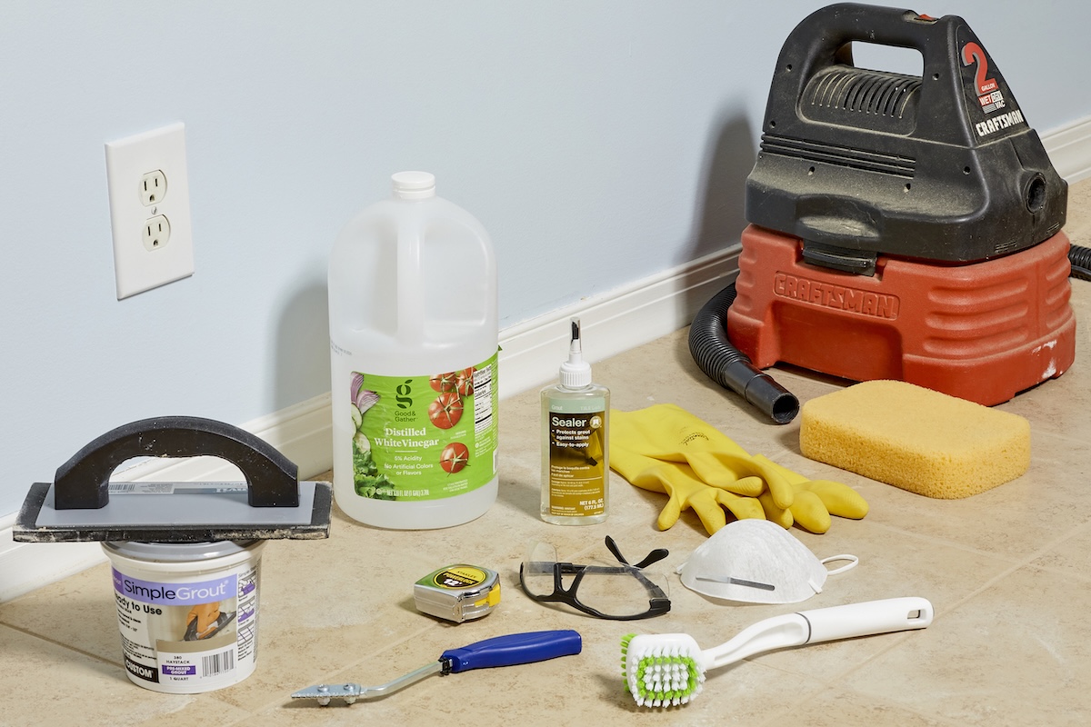 Materials used to repair grout, including vinegar, grout, grout saw, and more.