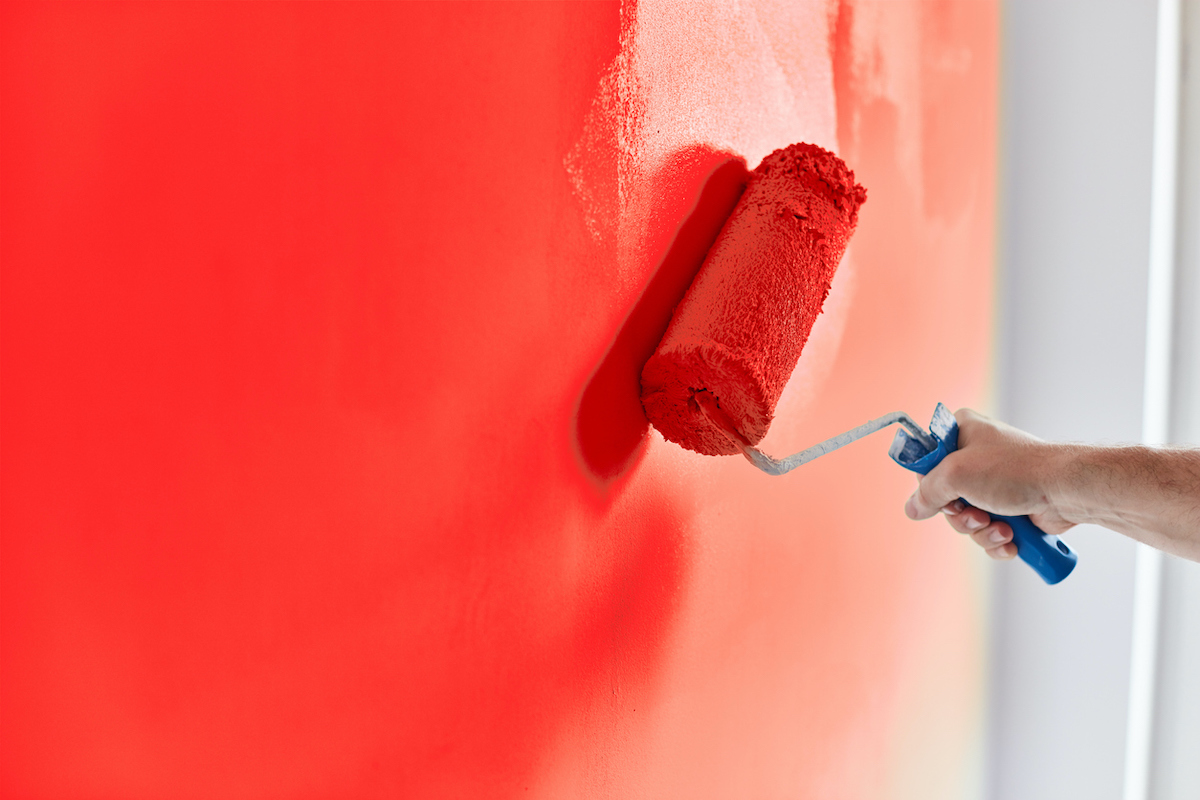 red paint roller with wet paint edge