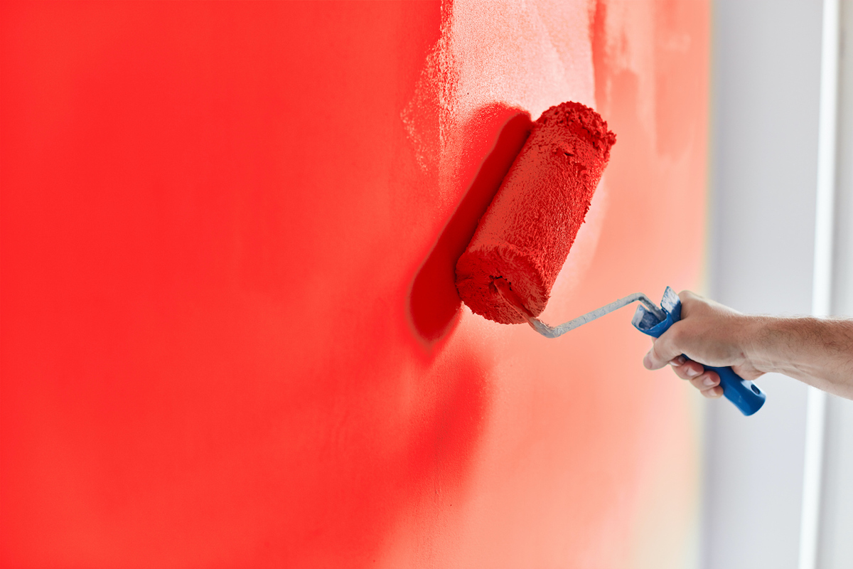 red paint roller with wet paint edge
