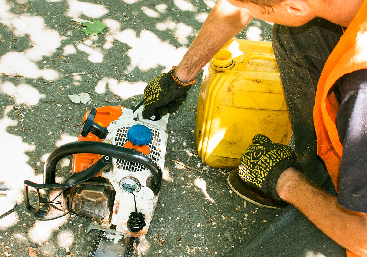 Pouring fuel into a chainsaw