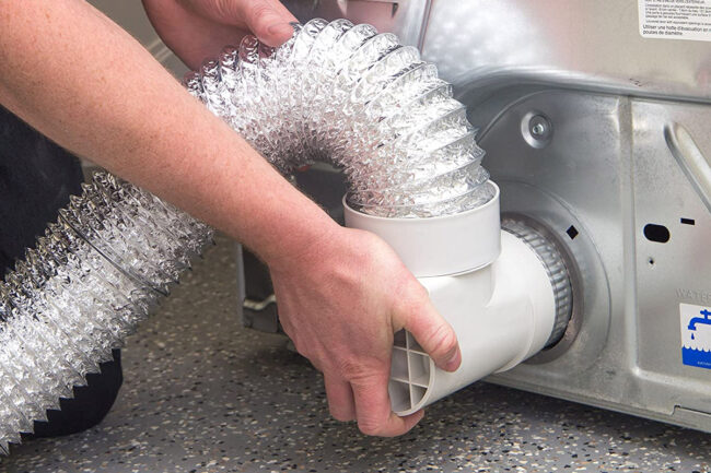 A person installing a dtyer vent hose for tight spaces to a dryer
