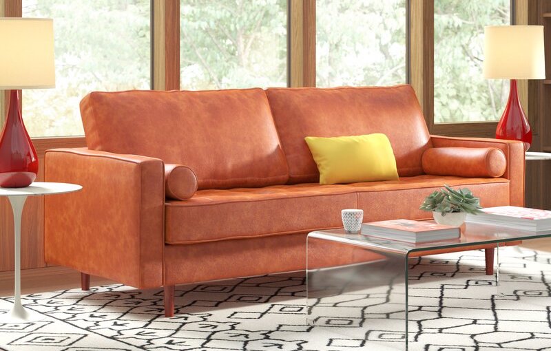 The best leather sofa option set up in front of a large window and next to a glass coffee table