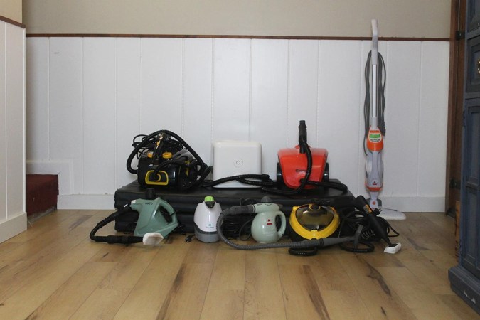 8 of the Best Upholstery Steam Cleaners lined up on wood floor