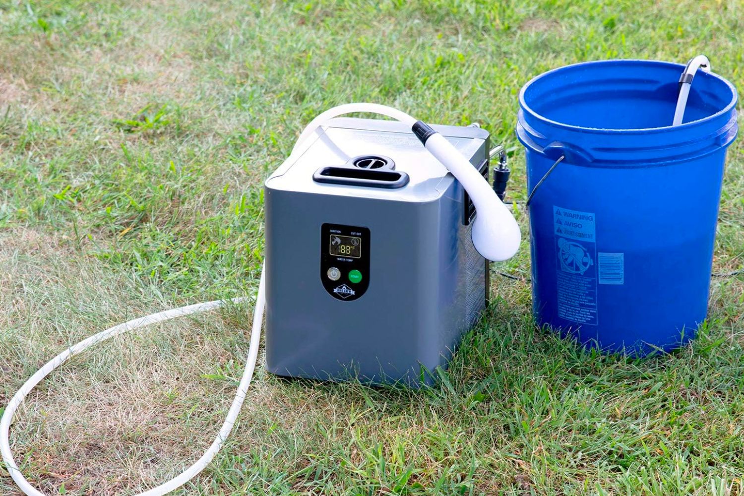 The best propane tankless water heater option on the ground next to a bucket with a shower hose and head