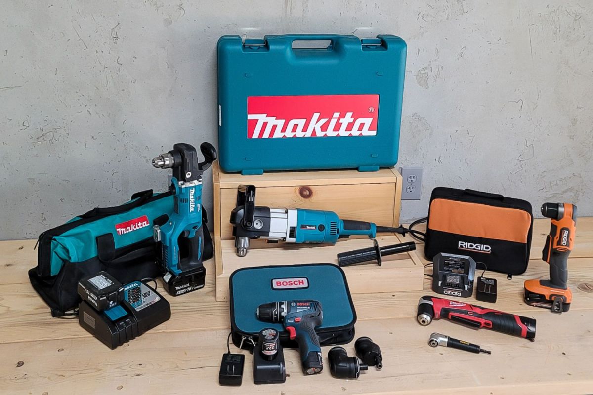 Six of the best right angle drill kits on a wood floor in front of a cement wall.