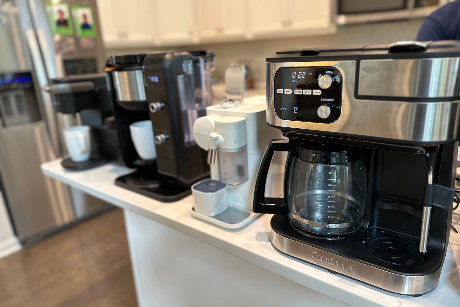 A closeup of a few machines within a kitchen-island lineup of the best dual coffee makers
