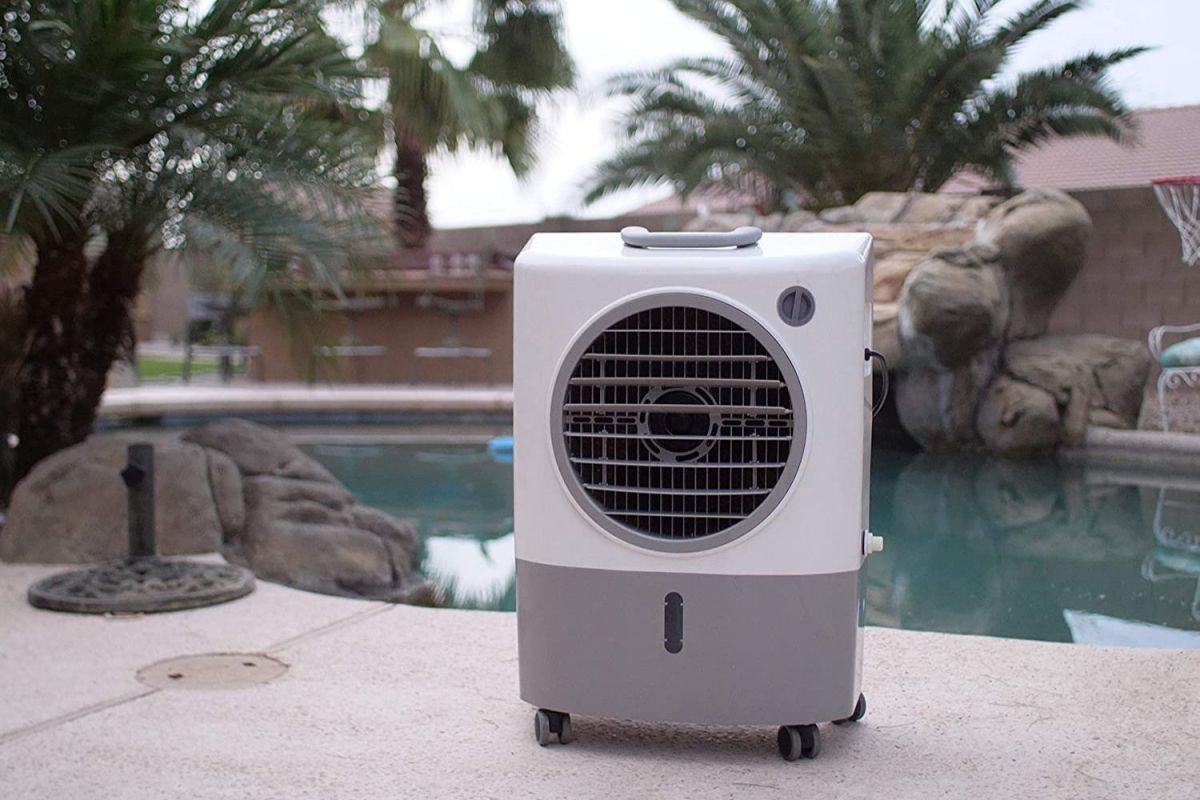 The best evaporative air cooler option on a cement patio next to an outdoor pool